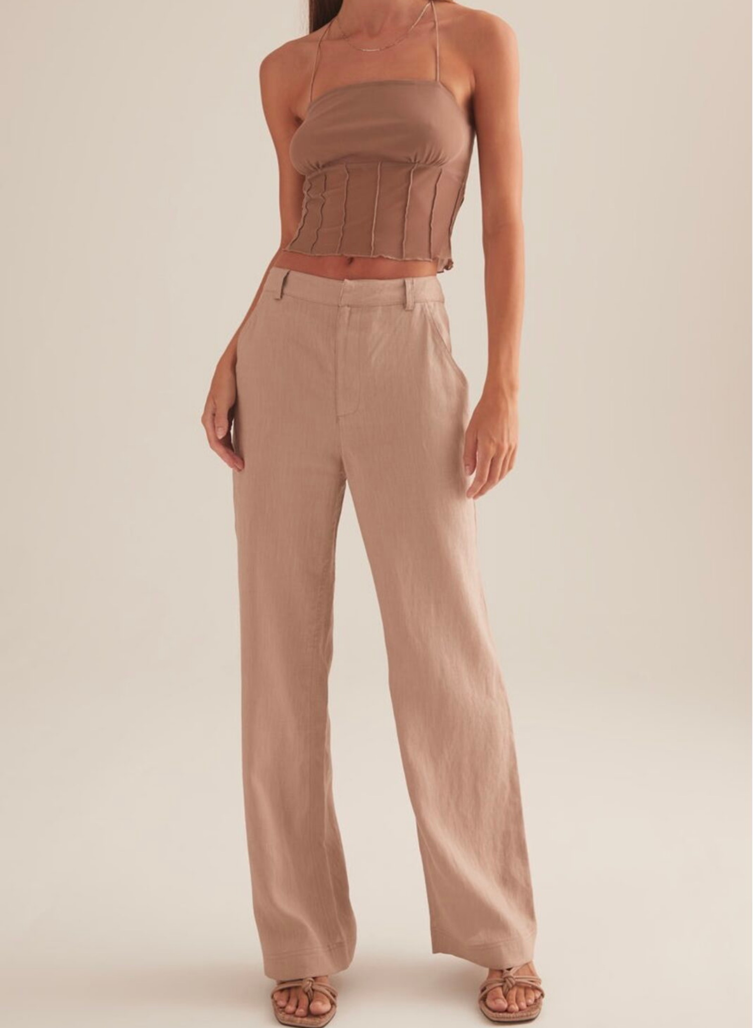 The Charmed top, cut in Stone colour way. A cropped mini top with spaghetti straps and vertical paneling under the ruched bust.