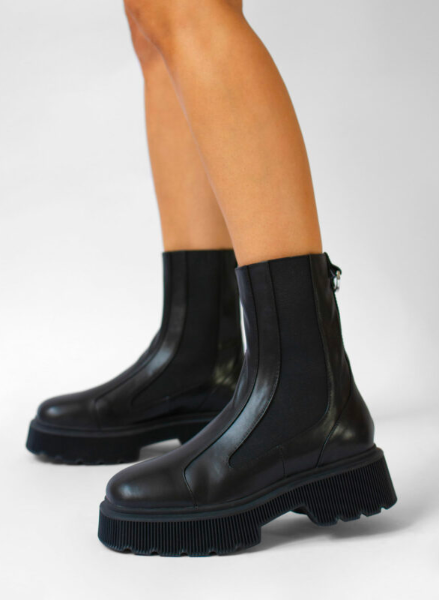 Ebony soft calf ankle boot, featuring a chunky rubber sole, elasticated sides and rounded toe. Ebony Soft Calf Leather Upper Leather Lining Rubber Sole Heel Height: 50mm approx.
