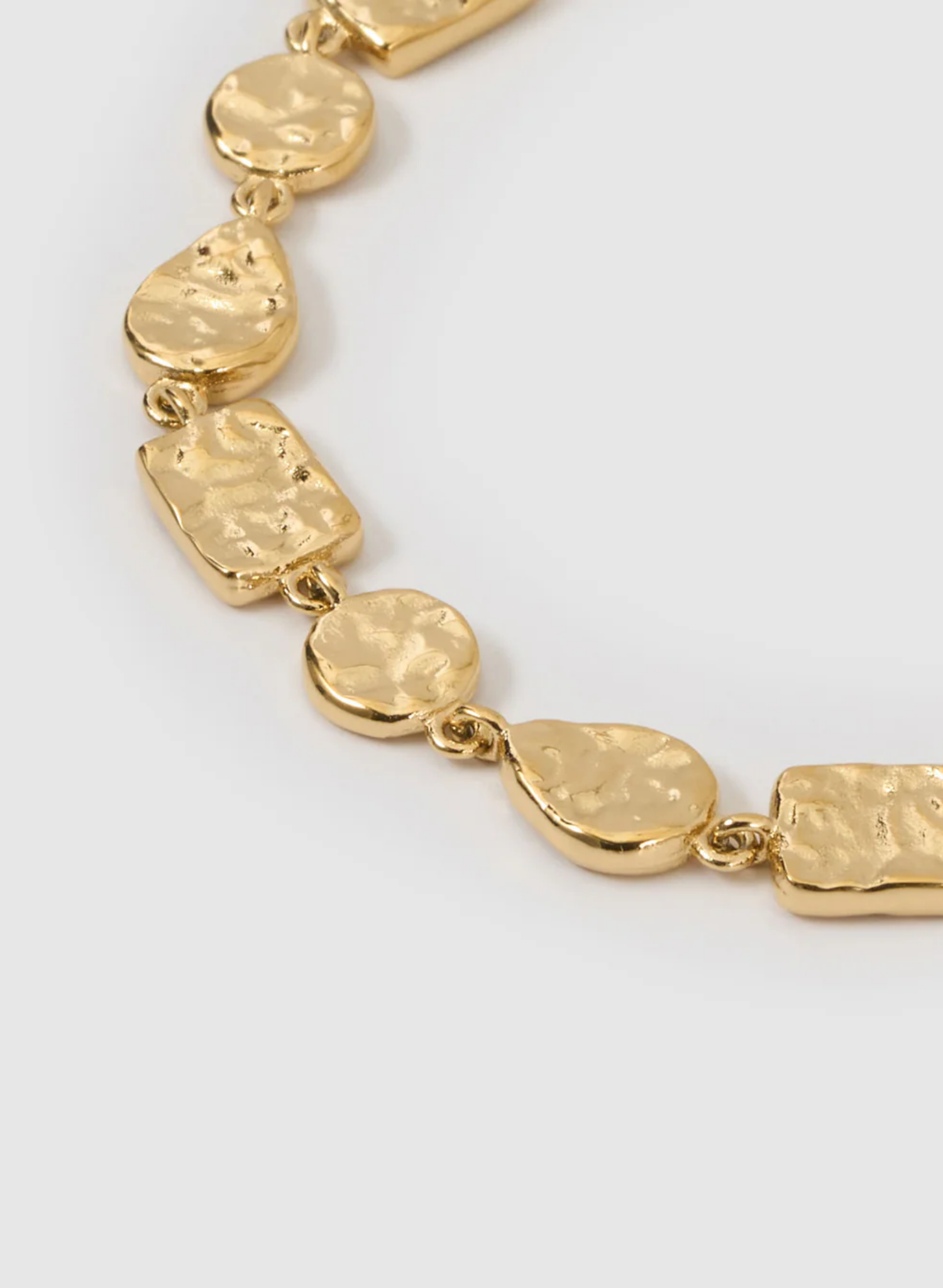Gold bracelet with textured links on a white background