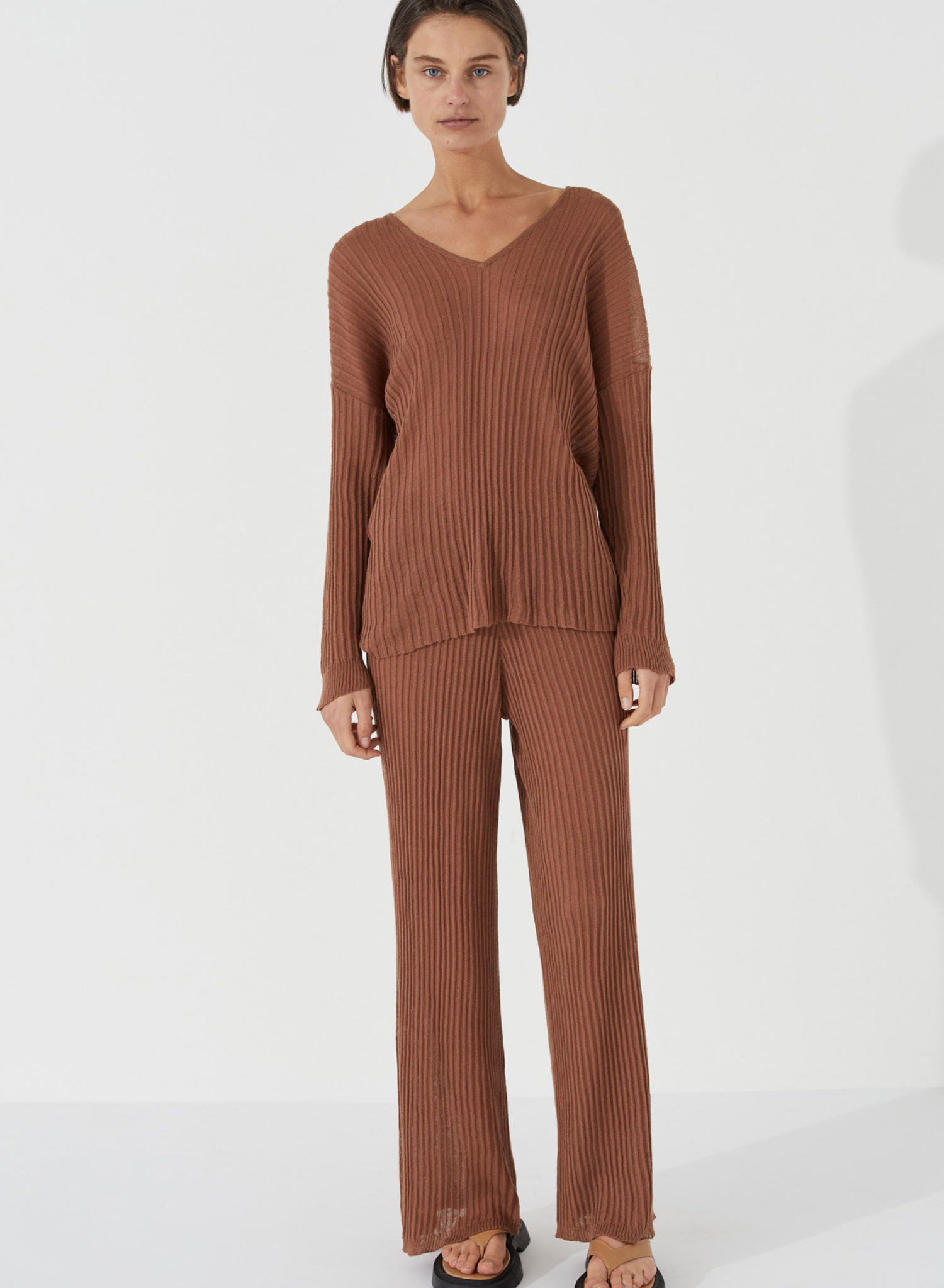 The Ribbed Knit Top by Zulu & Zephyr is a textured sheer fine knit, featuring a casual long sleeve with drop shoulder, and feminine V neckline. Inspired by the drape of tactile cloth and soft organic forms, this transeasonal essential may be paired with the coordinating Ribbed Knit Pants.