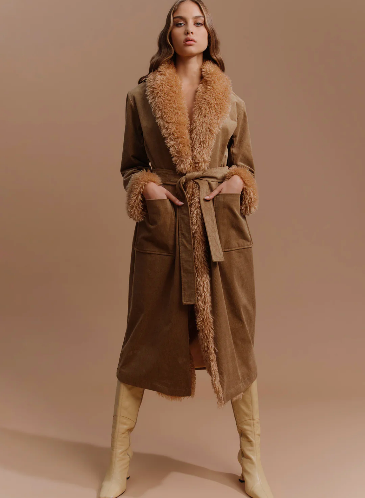 The Heaven Coat is our statement fur trim penny lane coat. The long-line fit is complimented by a fur collar and cuffs. The jacket can be cinched in at the waist with the matching belt or worn open over your favourite dress. Pair with your favourite boots and you are ready for this winter season.