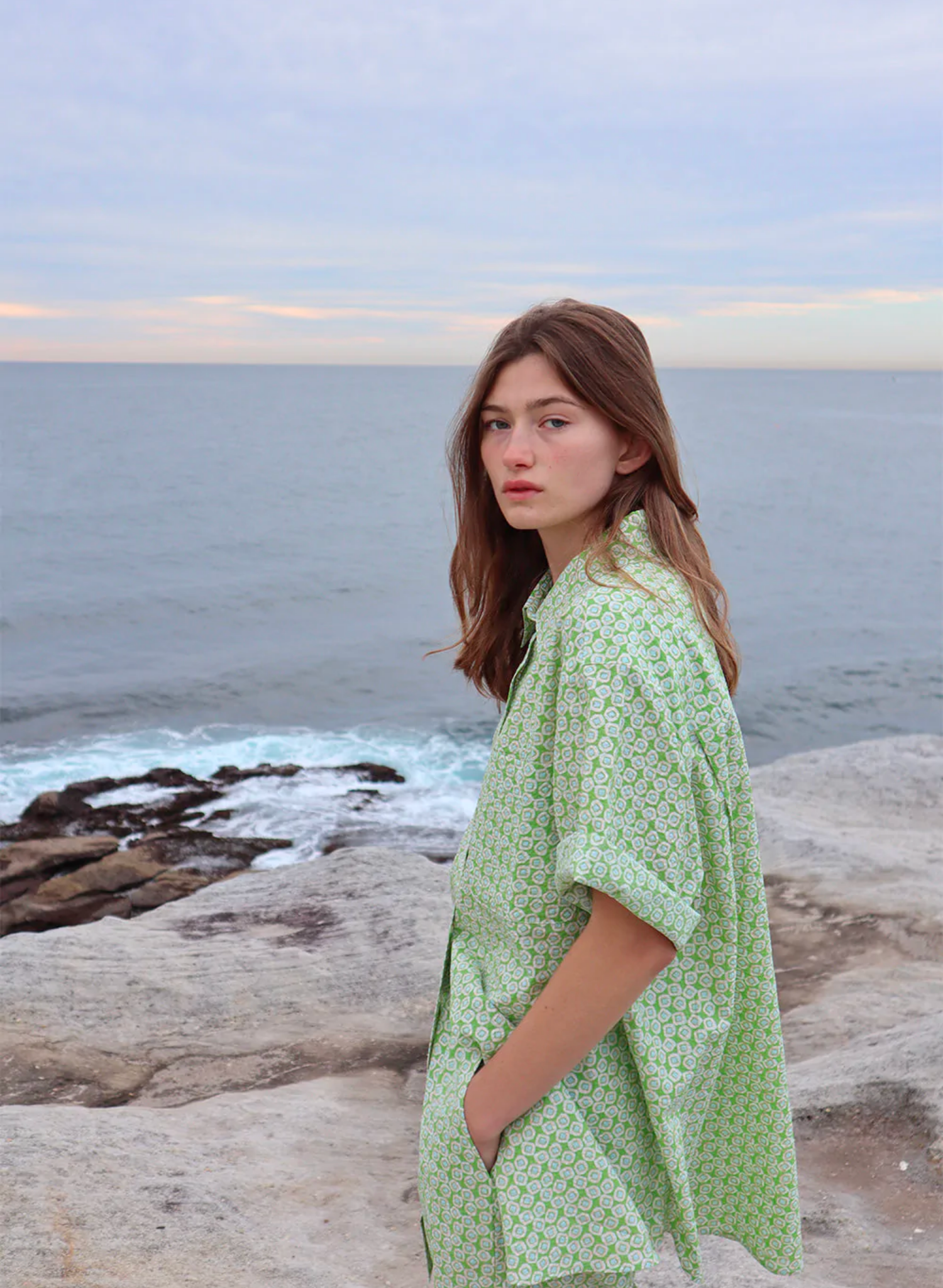 In a premium textural fabric, the Lola features classic button-up details and a soft green and white print. The style is cut with our signature oversized fit and features relaxed sleeves.