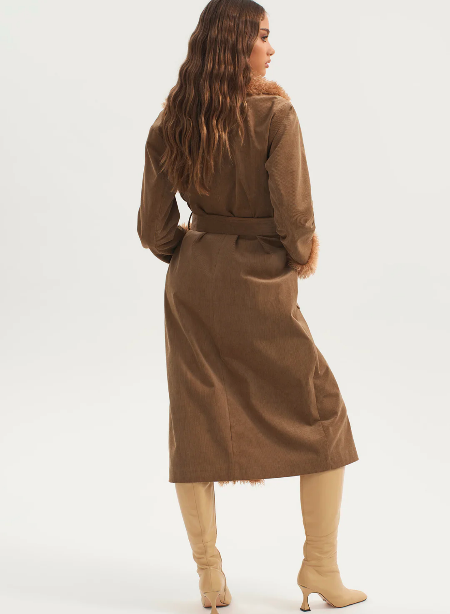 The Heaven Coat is our statement fur trim penny lane coat. The long-line fit is complimented by a fur collar and cuffs. The jacket can be cinched in at the waist with the matching belt or worn open over your favourite dress. Pair with your favourite boots and you are ready for this winter season.