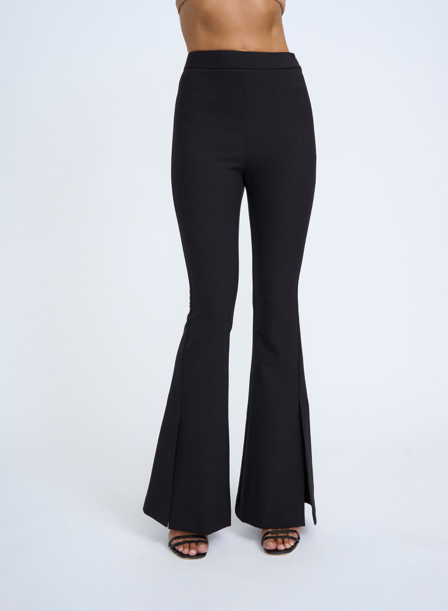 The Sliced Flare Knit Pant features a dramatic flared front split and is form fitting while flattering to the figure. The thick waistband has been designed to provide both comfort and support for all day wear. From your staple heels to sneakers, this pant is versatile and can be dressed up or down.