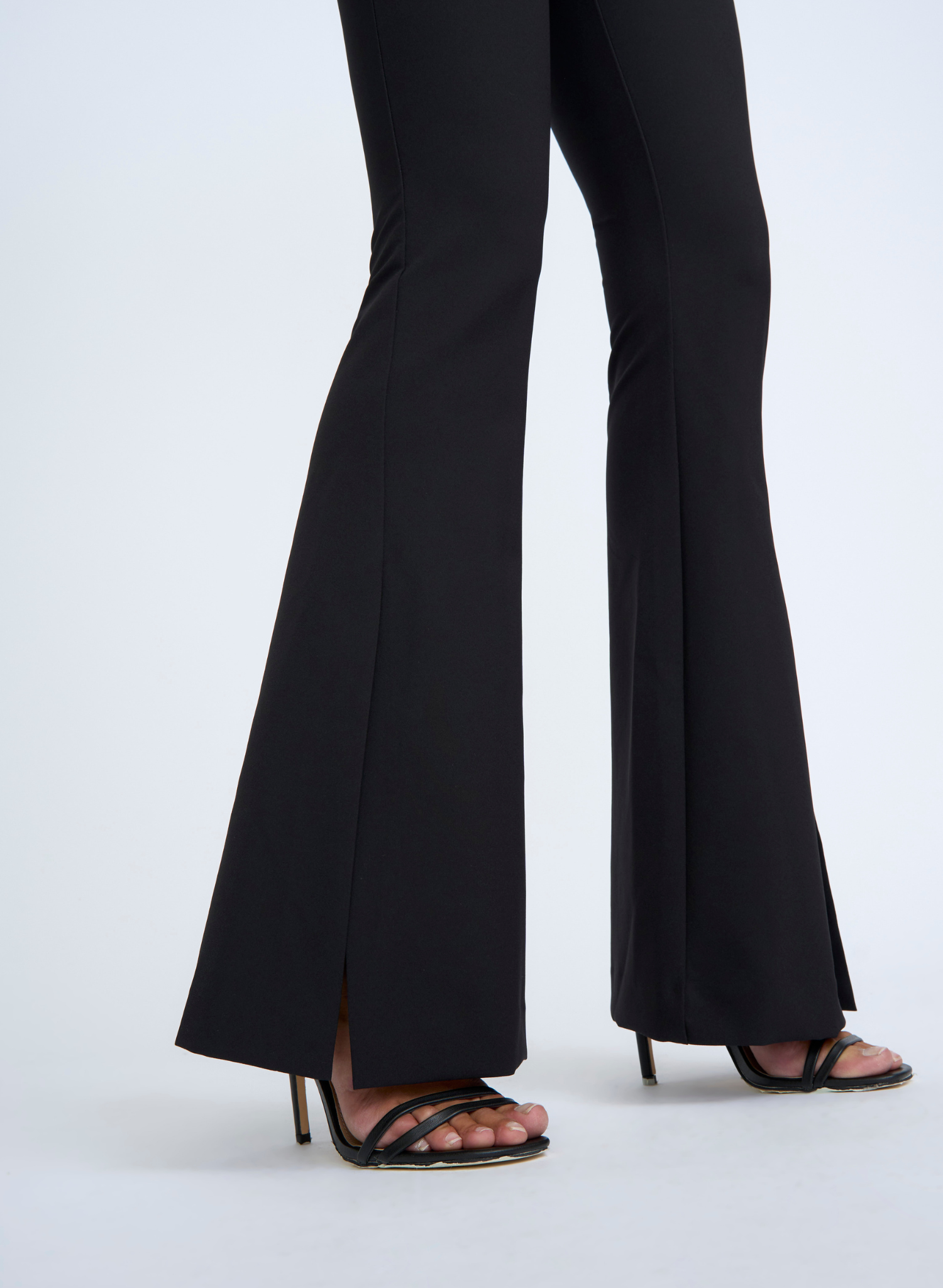 The Sliced Flare Knit Pant features a dramatic flared front split and is form fitting while flattering to the figure. The thick waistband has been designed to provide both comfort and support for all day wear. From your staple heels to sneakers, this pant is versatile and can be dressed up or down.
