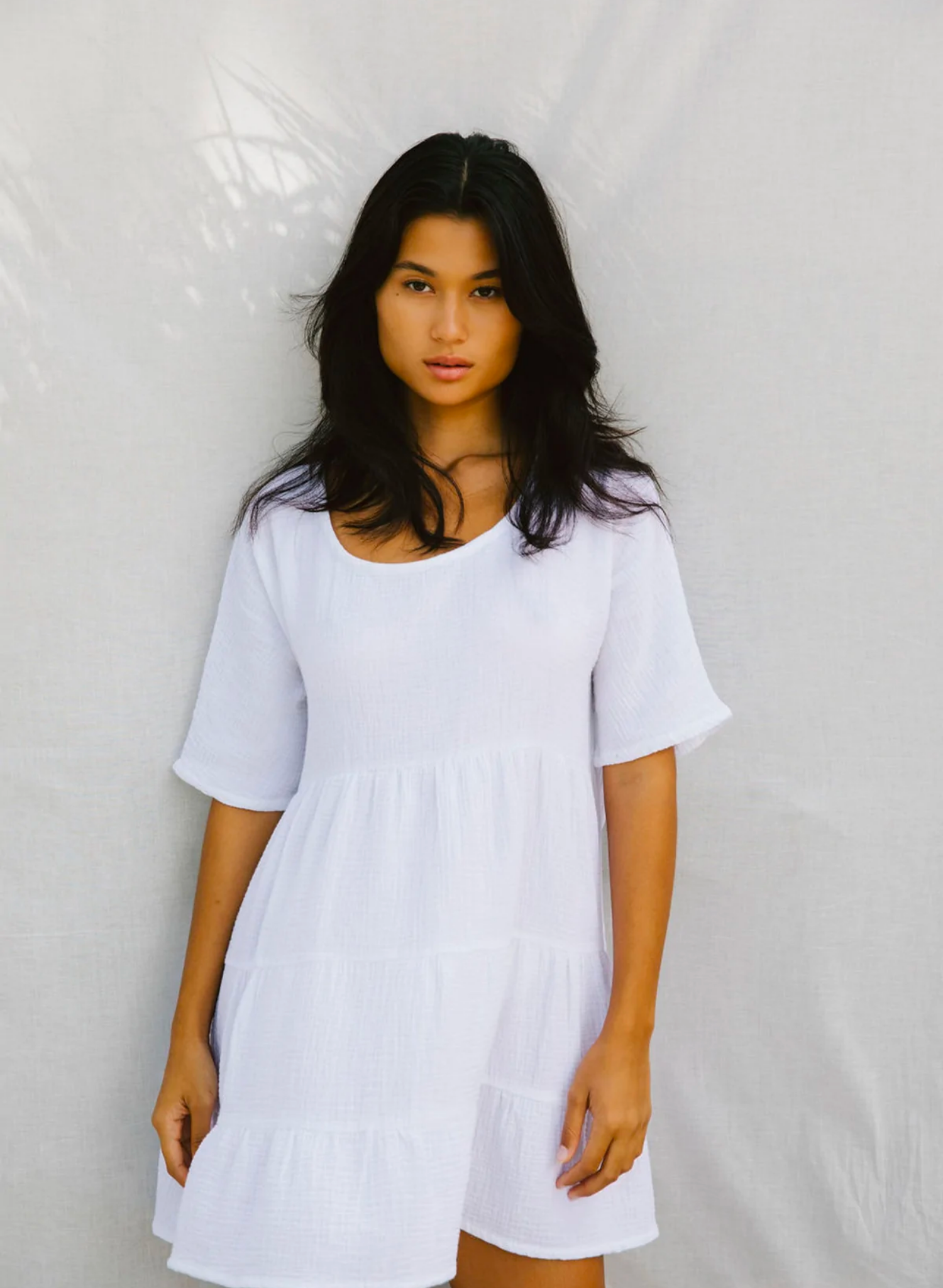 This oversized baby-doll is the perfect chuck on mini dress. Made from the softest natural cotton bubble, you will want to live in this dress all season long.Featuring a flattering scooped neckline a longer sleeve and a tiered baby doll skirt. Paired with sandals or heels it makes a cute day or night outfit.