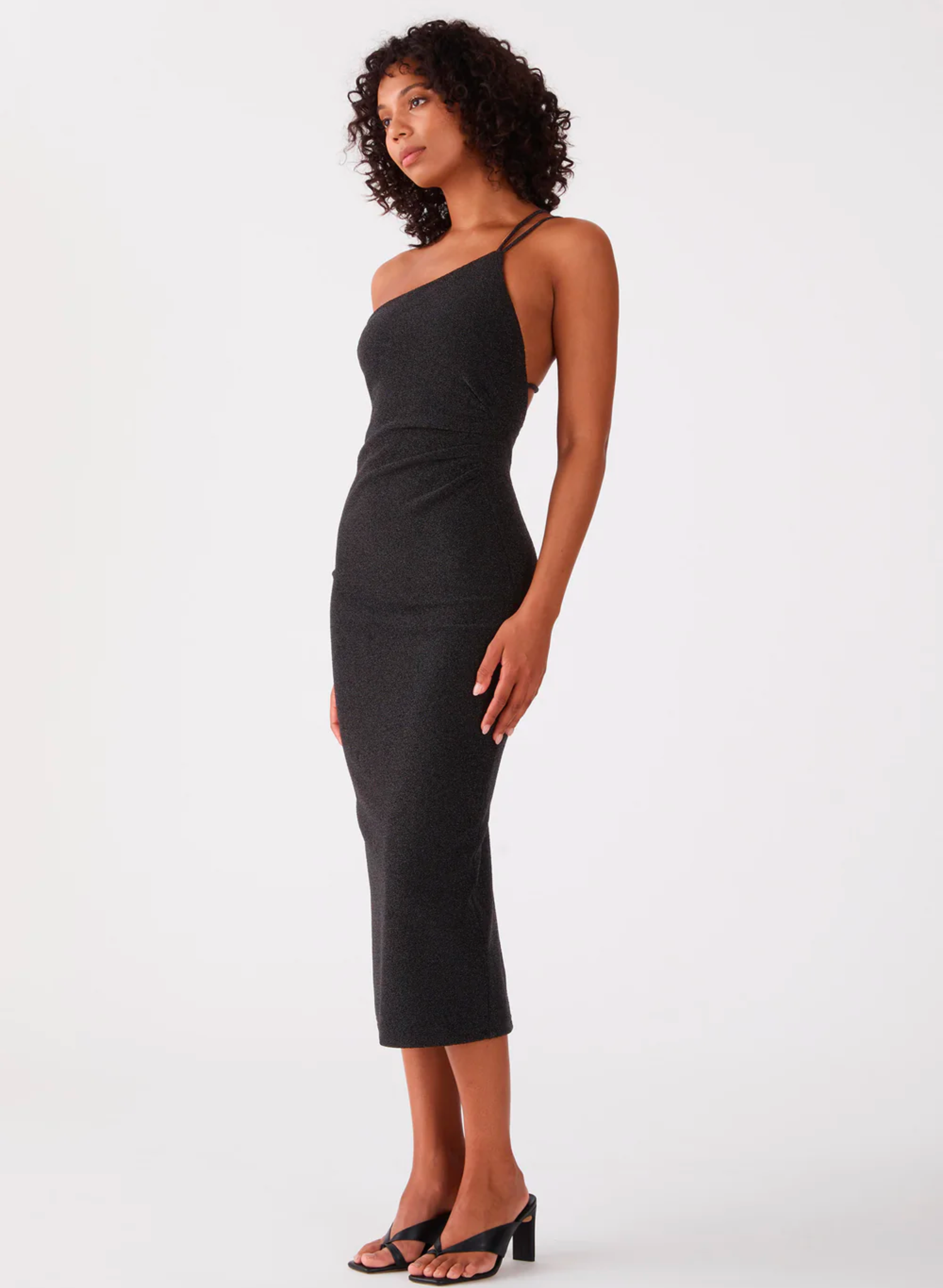 Get ready to sparkle in the San Sloane Golda Midi Dress! This show-stopping dress is crafted in a sparkle metallic jersey and fully lined for a perfect fit. Featuring an asymmetric neckline, gathers at the waist and adjustable strap detailing, you'll be turning heads in this bodycon midi with its low scoop back and stretch fabric. 