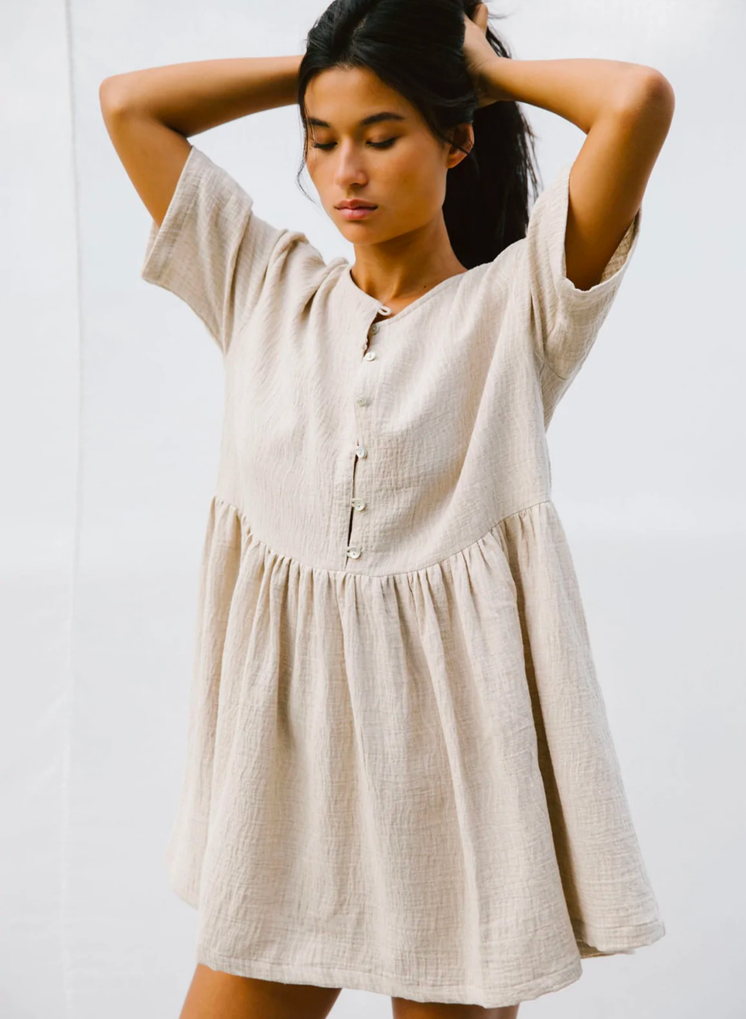 This cool and breezy piece is the perfect ‘chuck on’ to get you through those warmer months. Made from a lightweight cotton. The Darcey dress has become a cult favourite at TBR and we know you will love it. Featuring an oversized fit, wide neckline, button-down neckline, babydoll skirt and a flattering wide sleeve.